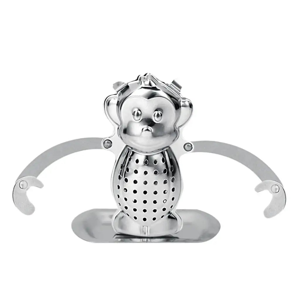 Monkey tea infuser with long arms resting on a mug
