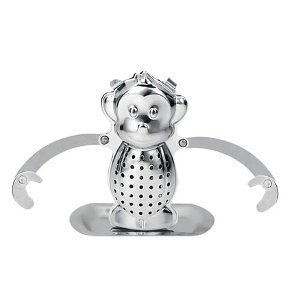 Monkey tea infuser with long arms resting on a mug