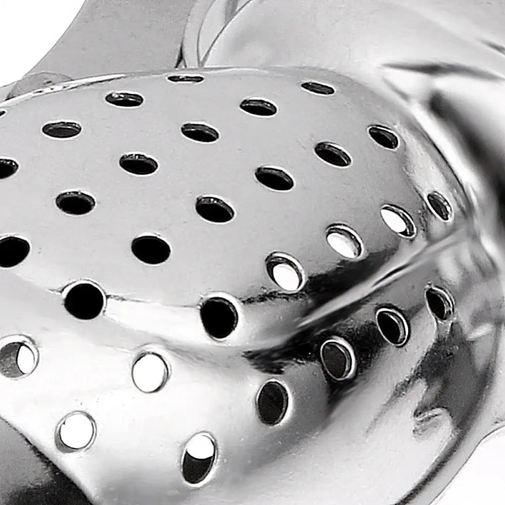 Monkey tea infuser hanging on the edge of a white mug