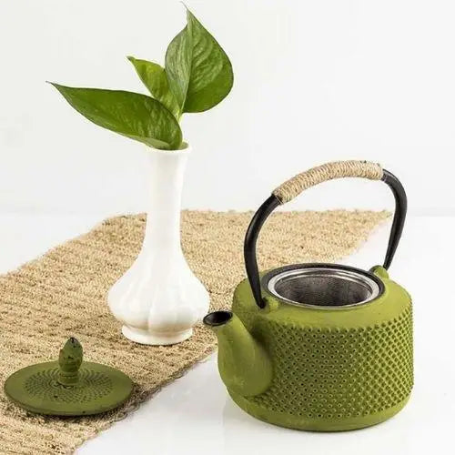 40 oz moss green cast iron teapot on a wooden table setting