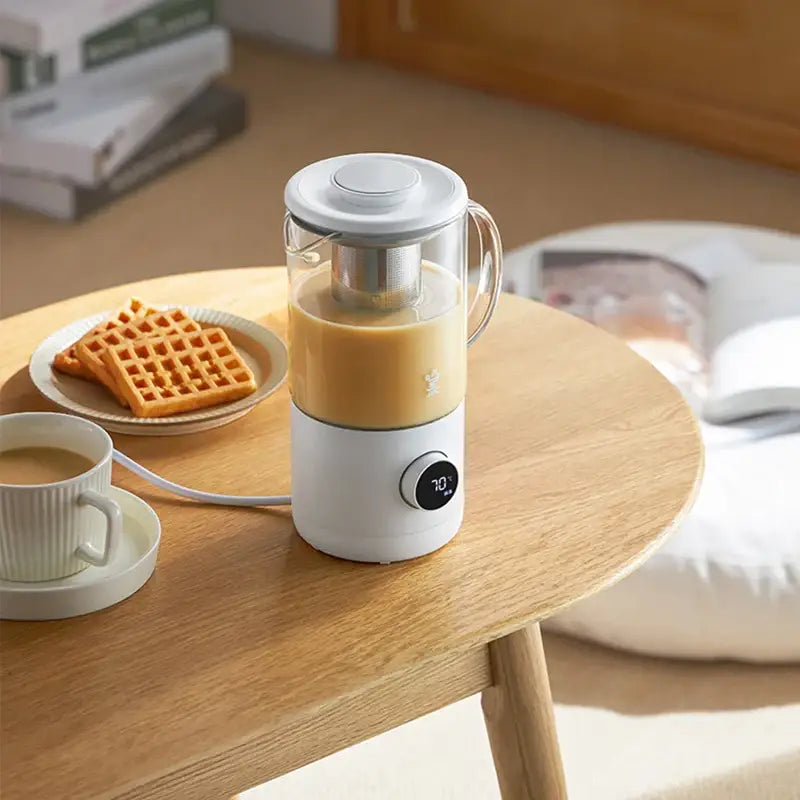 500ml glass tea maker pouring freshly brewed loose leaf tea into a ceramic mug