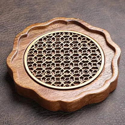 Teapot placed on natural wood trivet showing stable, flat resting position