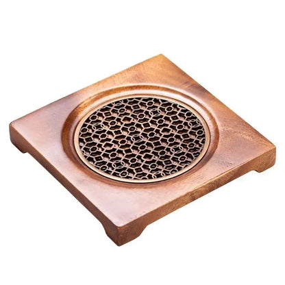 Elegant natural wood teapot trivet with decorative grid, angled detail view