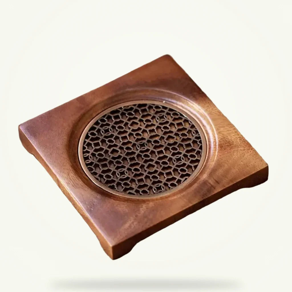 Natural wood teapot trivet with decorative grid pattern, packshot on plain background