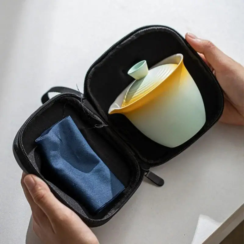 Portable tea set for two, porcelain cups nested inside teapot