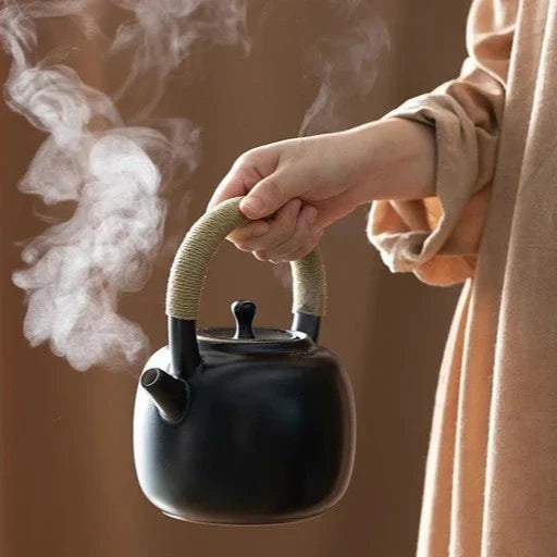 Black Scandinavian ceramic teapot 750ml with matching cup on dark surface