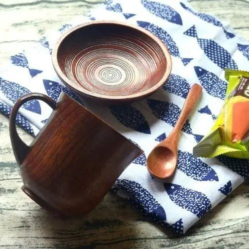 Olive wood tea cup with saucer on wooden table