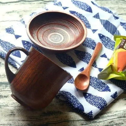 Olive wood tea cup with saucer on wooden table