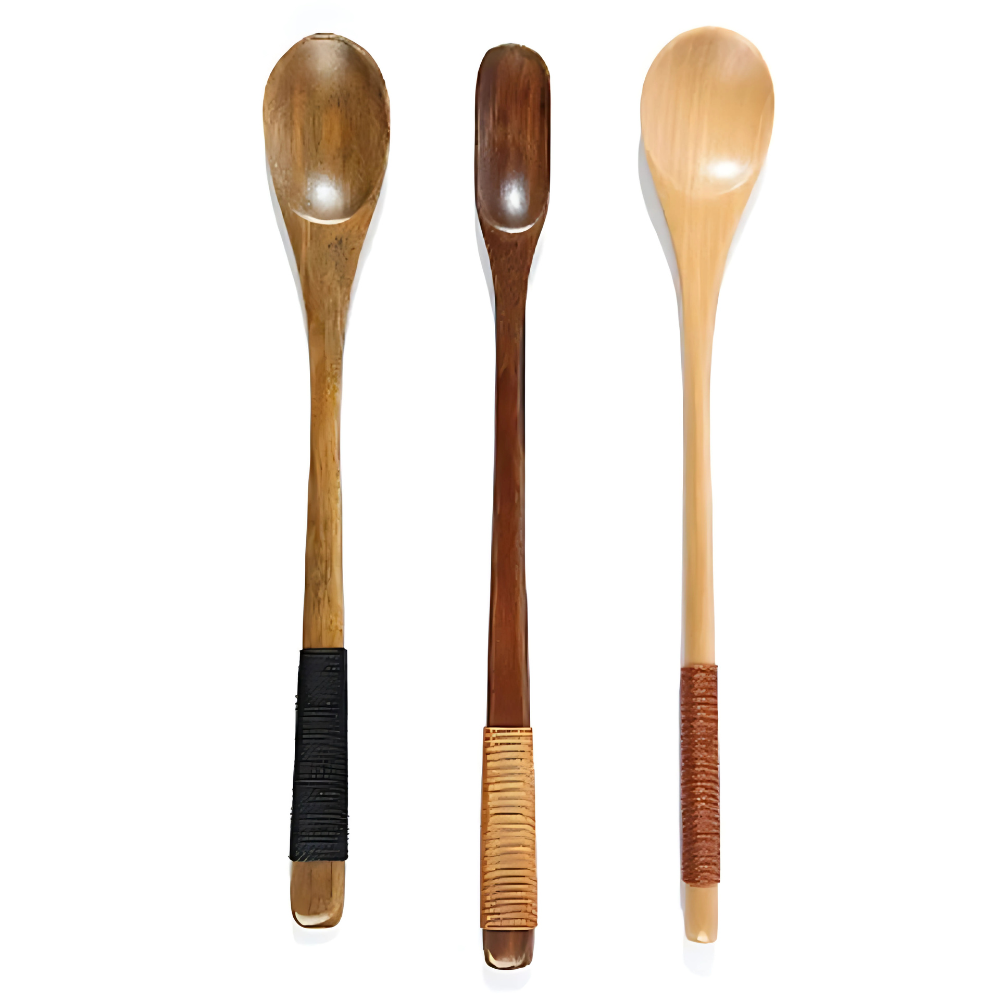 Olive wood tea spoon resting on saucer