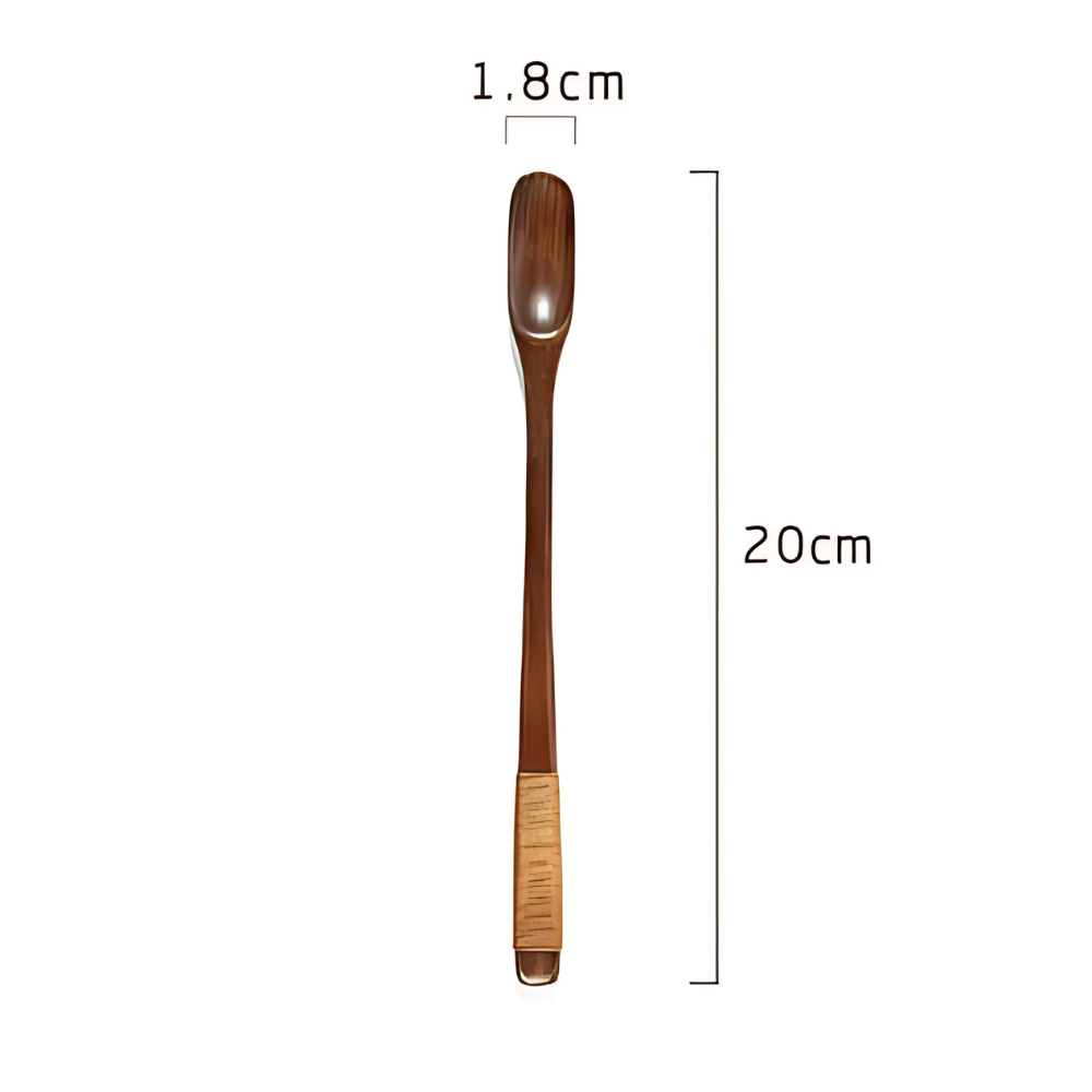 Natural olive wood tea spoon on wooden board