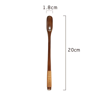 Natural olive wood tea spoon on wooden board