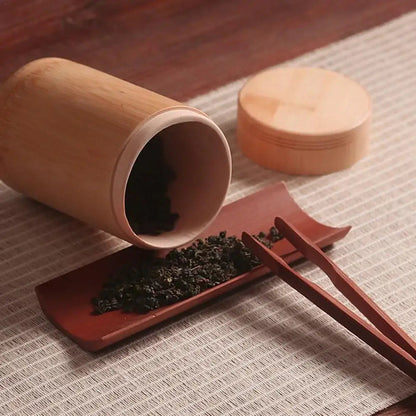 Bamboo tea canister with lid open showing interior depth for loose leaf scooping