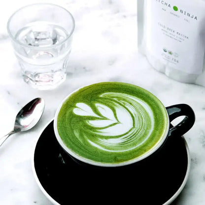 Whisking matcha green tea powder in a ceramic bowl