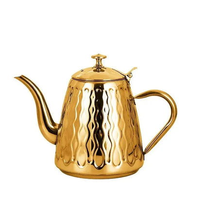 Gold oriental induction teapot with long spout and ornate handle, stovetop