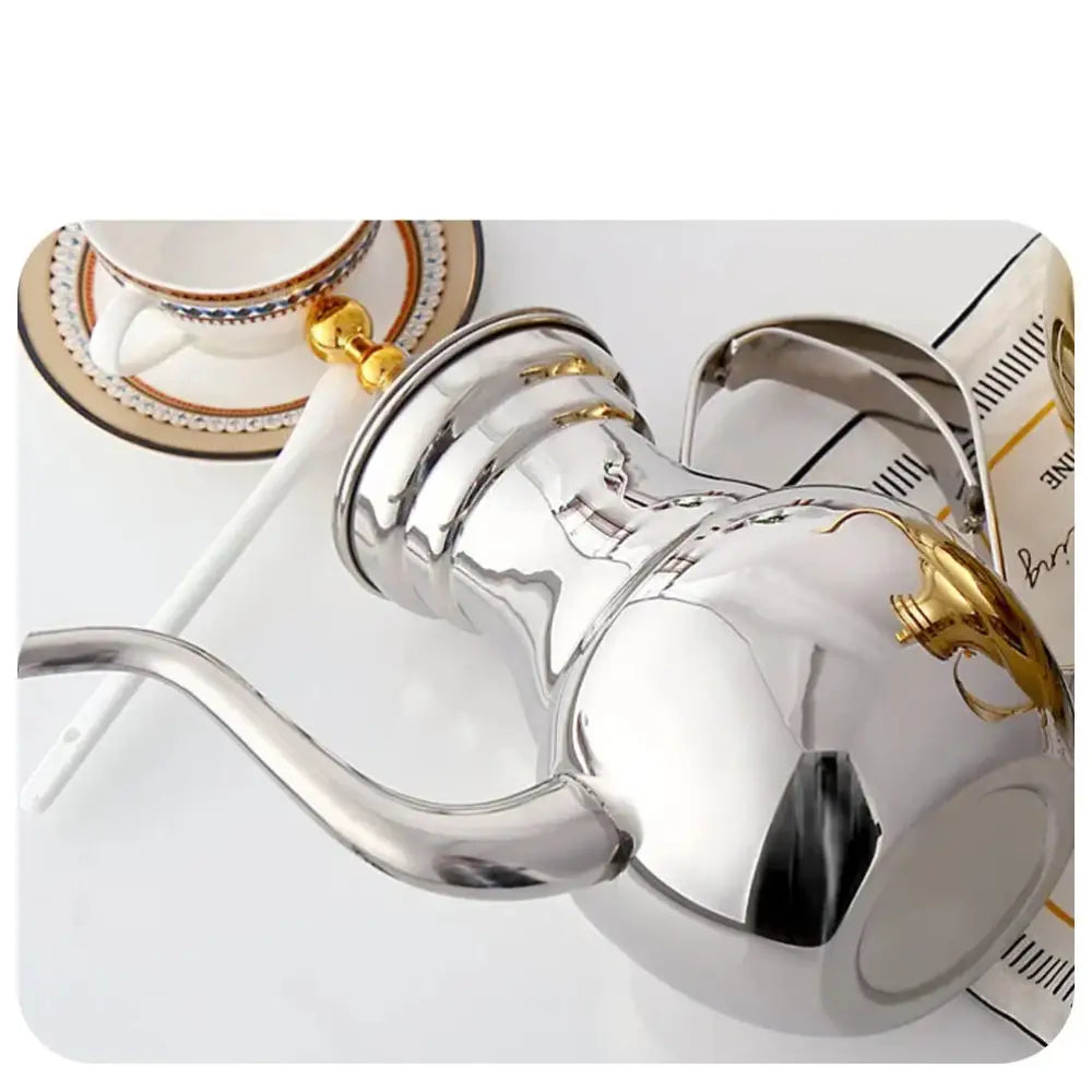 Gold Oriental stainless steel teapot showing decorative arched handle and side profile