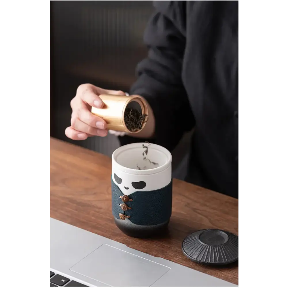 Panda tea infuser with green tea in a mug