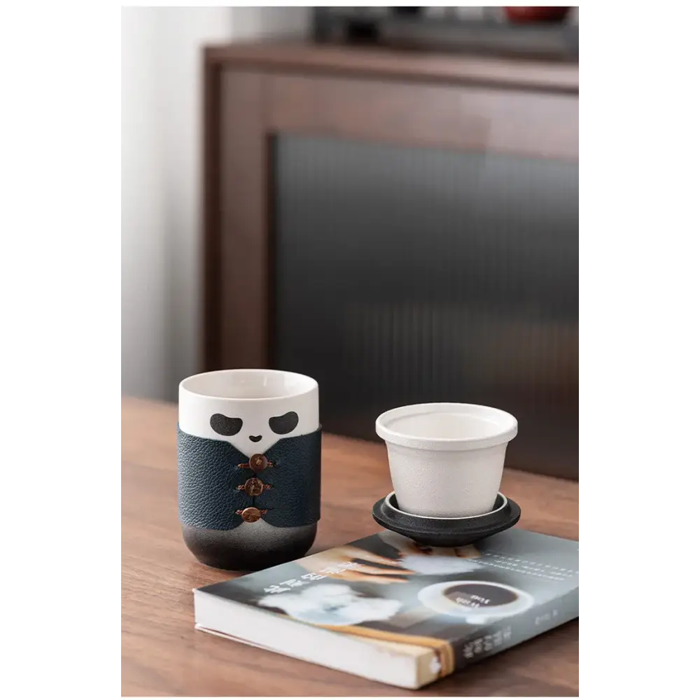 Panda tea infuser on a wooden table with tea cup