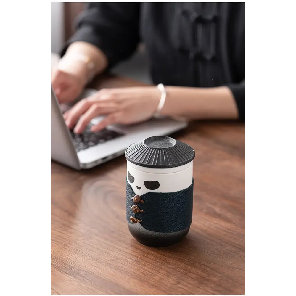 Panda tea infuser being lifted from a cup