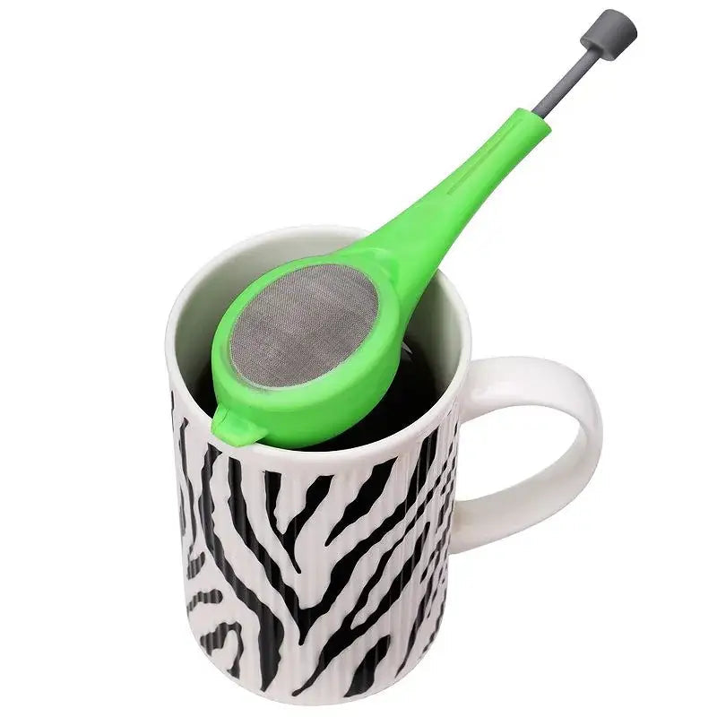 Plastic tea infuser with press on a kitchen counter