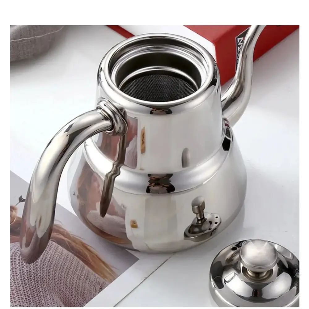 Removable mesh infuser screen inside stainless steel induction teapot, detail view