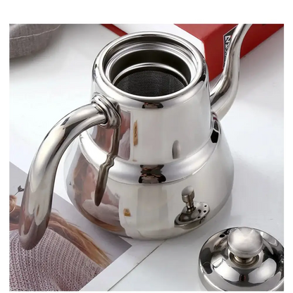 Removable mesh infuser screen inside stainless steel induction teapot, detail view