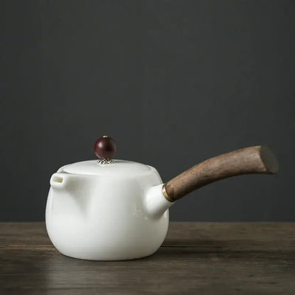 Porcelain teapot with infuser, 19x7cm size, on a wooden table