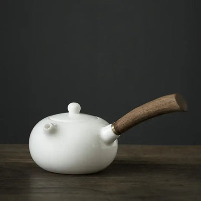 Small porcelain teapot with infuser, 18x8cm, with a cup of tea