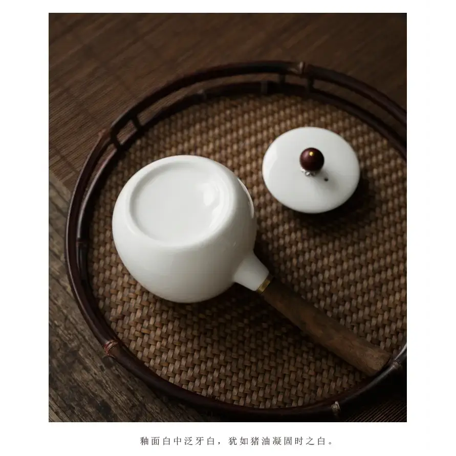 White porcelain teapot with infuser, side view