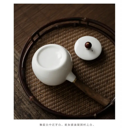 White porcelain teapot with infuser, side view