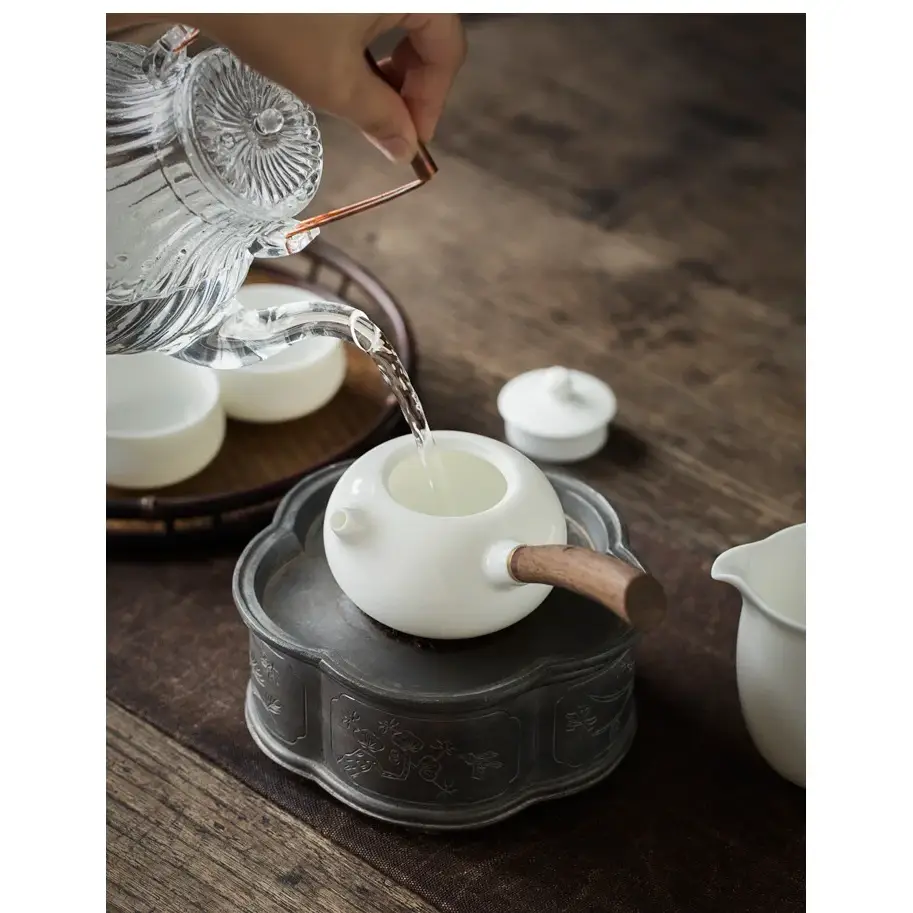 Porcelain teapot with infuser, top view showing lid
