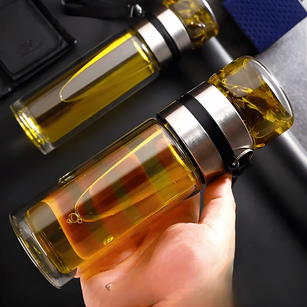 Stainless steel strainer detail inside glass tea infuser bottle, full-length filter view