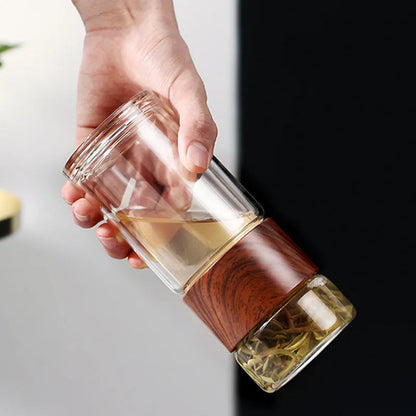 Close-up of wooden-look ring grip on portable glass teapot for comfortable one-hand hold