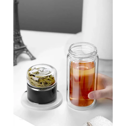 Portable tea infuser bottle with cup and tea leaves