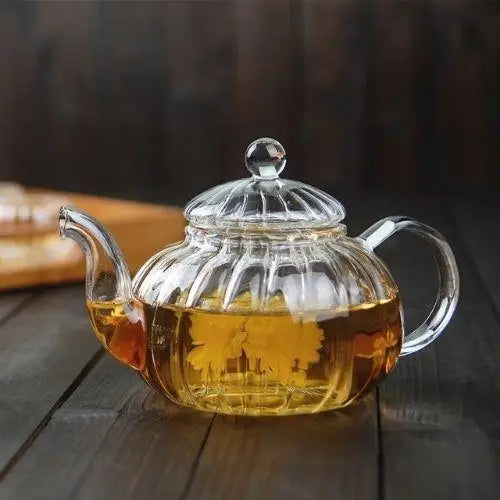 Clear glass pumpkin teapot full view on white background