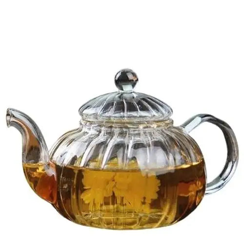 Pumpkin shaped glass teapot with amber tea inside