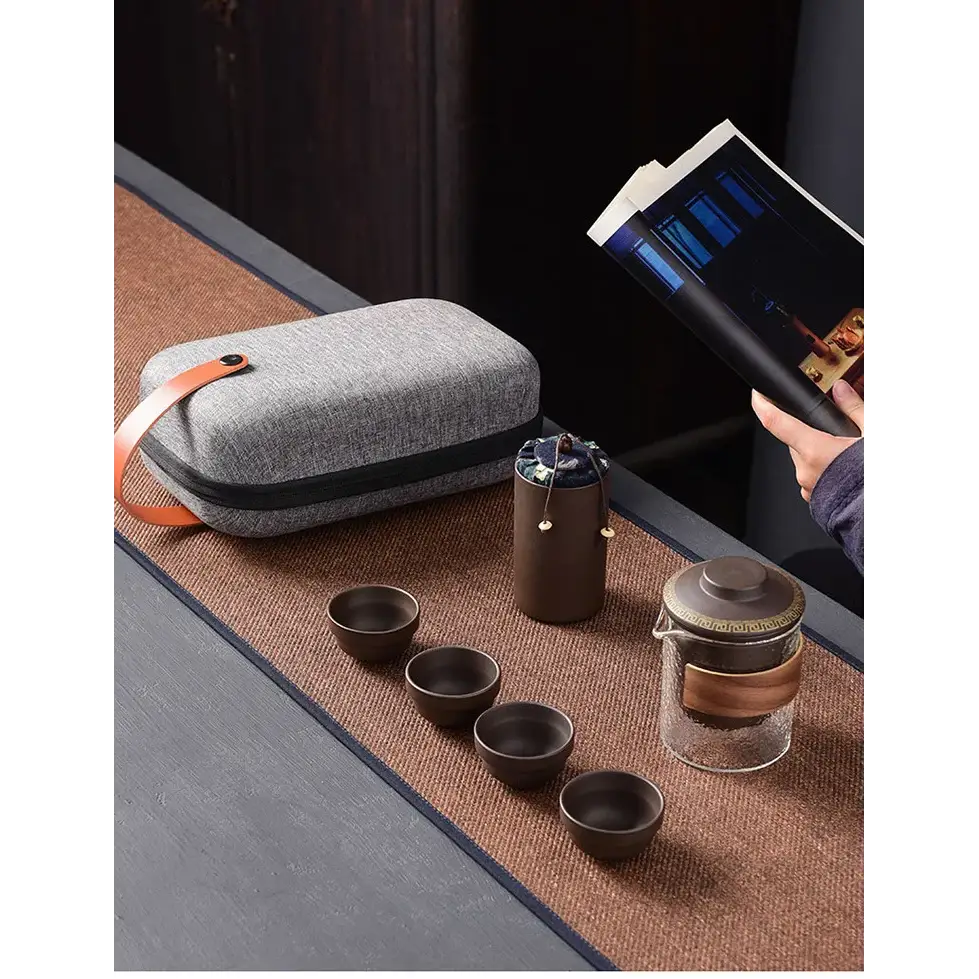 Purple clay tea set with cups and open carrying case showing padded interior