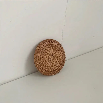 Raffia coaster with a cup of tea on a wooden table