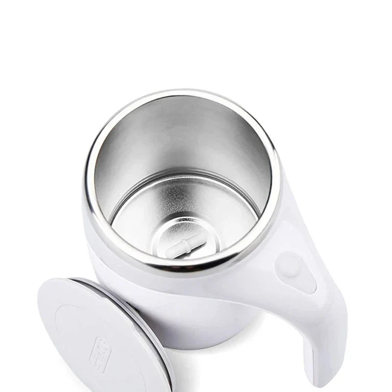 Rechargeable self-stirring mug with magnetic mixer used on a desk beside a laptop