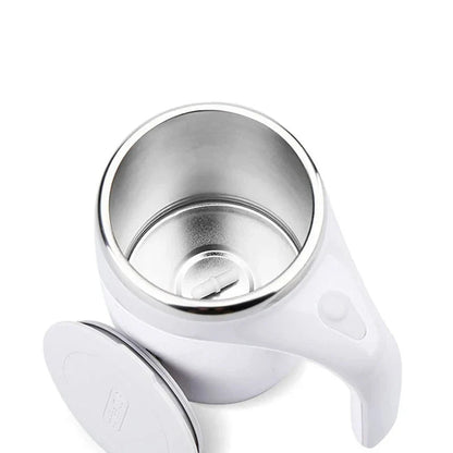 Rechargeable self-stirring mug with magnetic mixer used on a desk beside a laptop