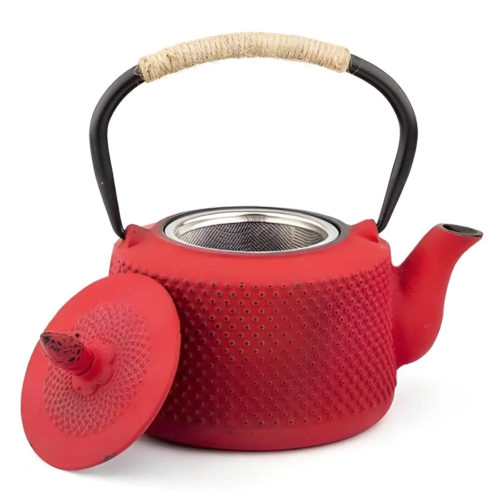 Close-up of red enamel-lined cast iron teapot spout and handle
