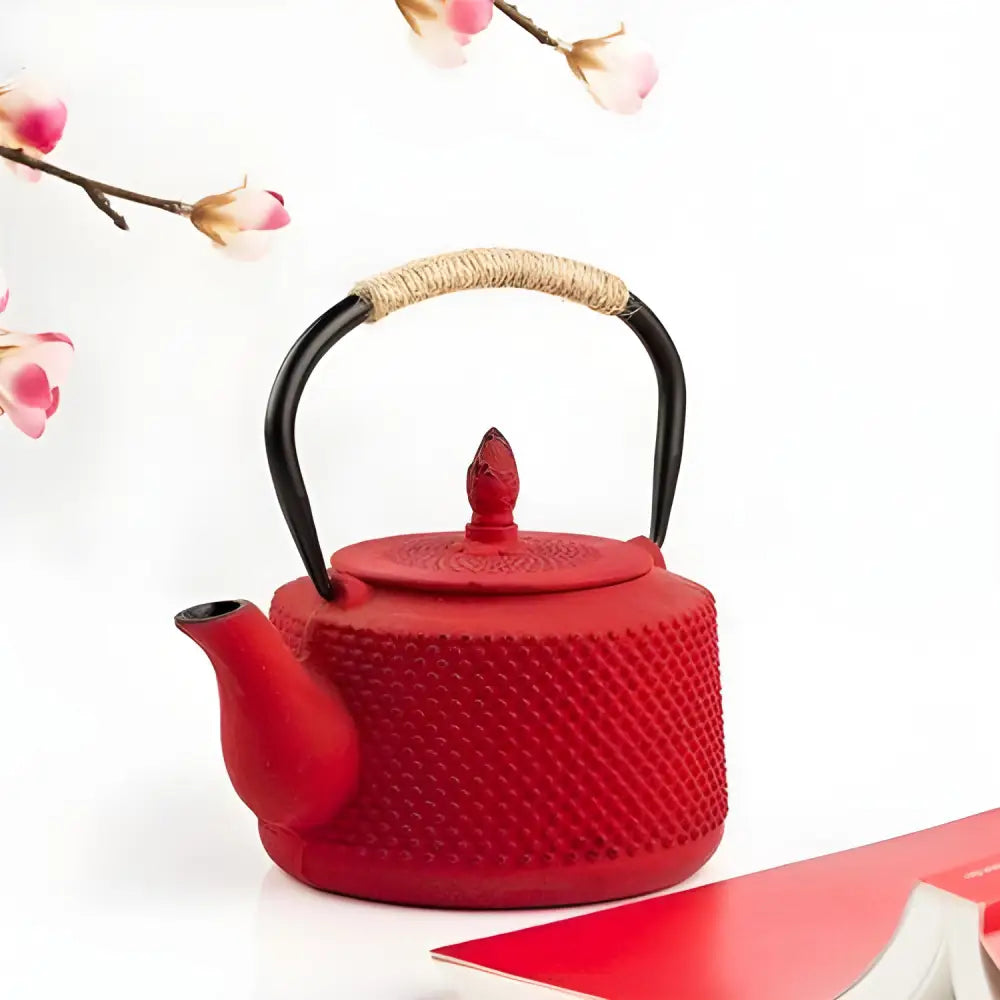 Japanese cast iron teapot in red on a wooden table, lid detail