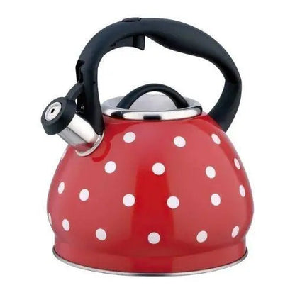 Red whistling teapot with white polka dots on stovetop