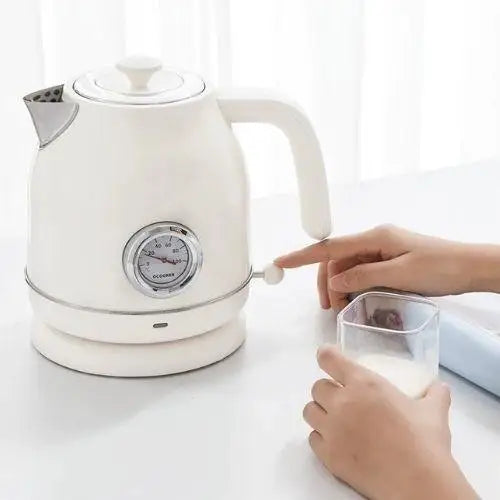 Retro white electric kettle pouring hot water