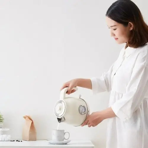 Retro white kettle with steam rising