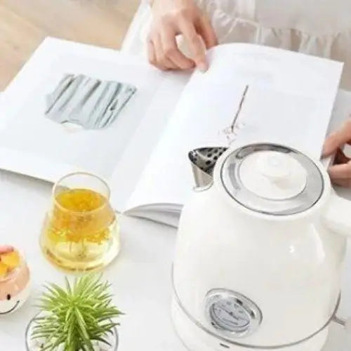 Elegant white electric kettle in kitchen