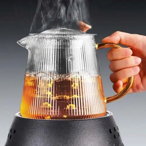 Clear ribbed glass teapot being used to brew loose-leaf tea