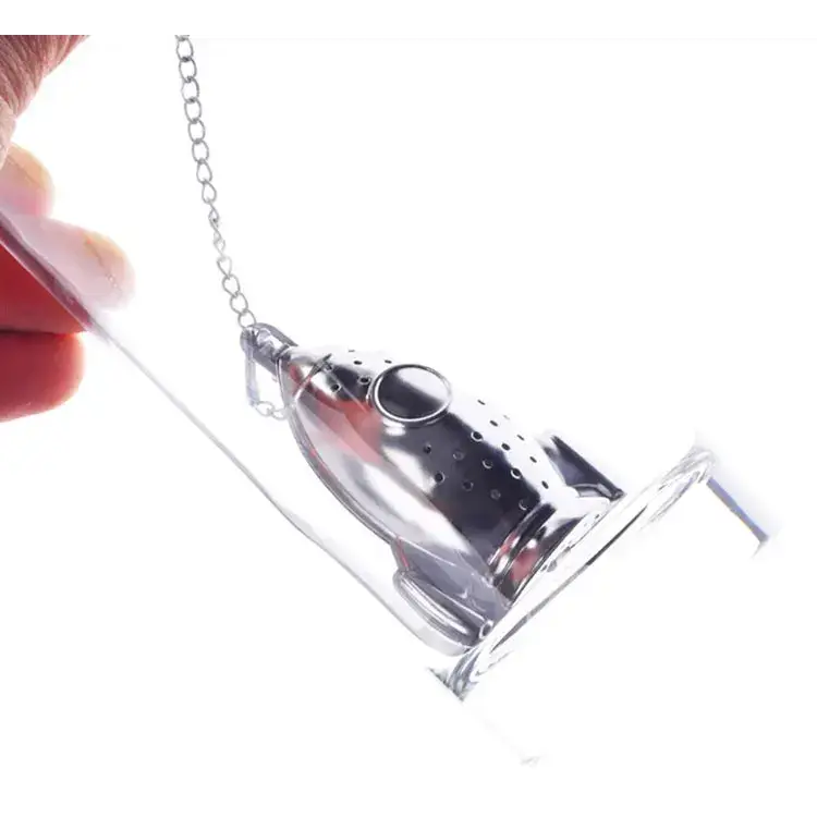 Rocket tea infuser with tea leaves beside it