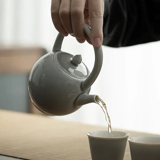 Round ceramic teapot on kitchen table