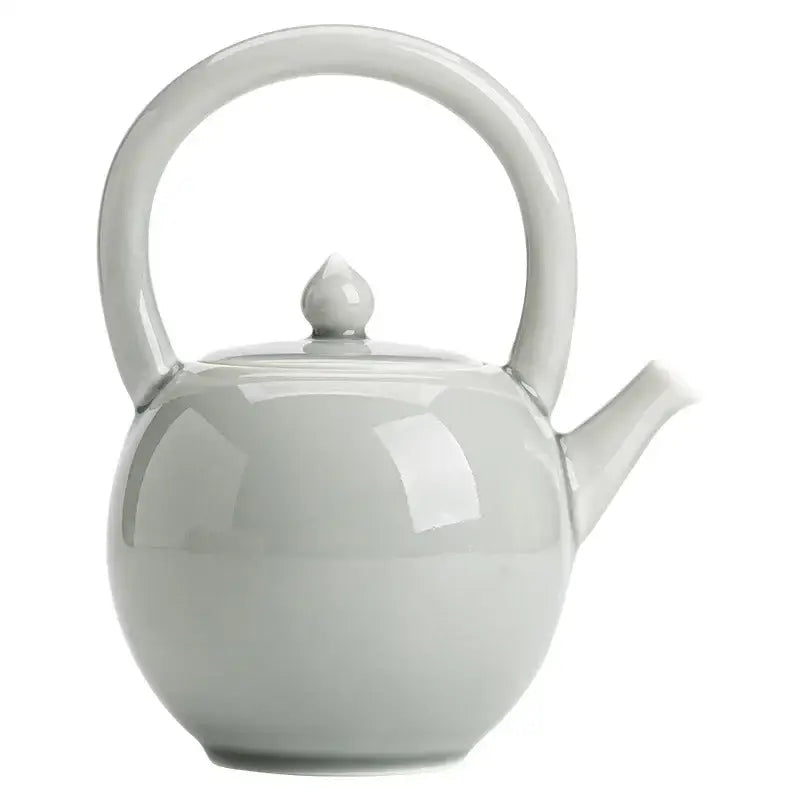 White porcelain teapot with tea cup