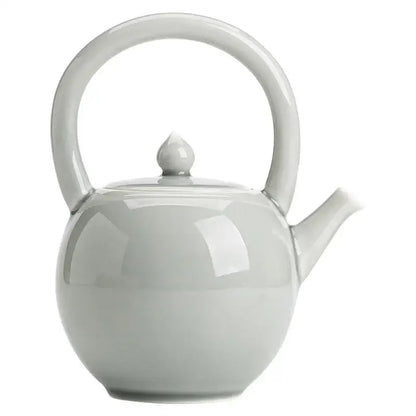 White porcelain teapot with tea cup
